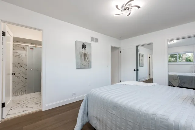 a bedroom with a bed and a chandelier