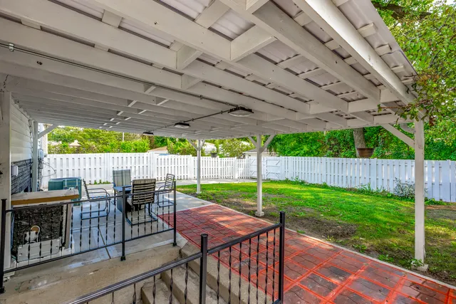 a view of a patio with table and chairs with wooden floor