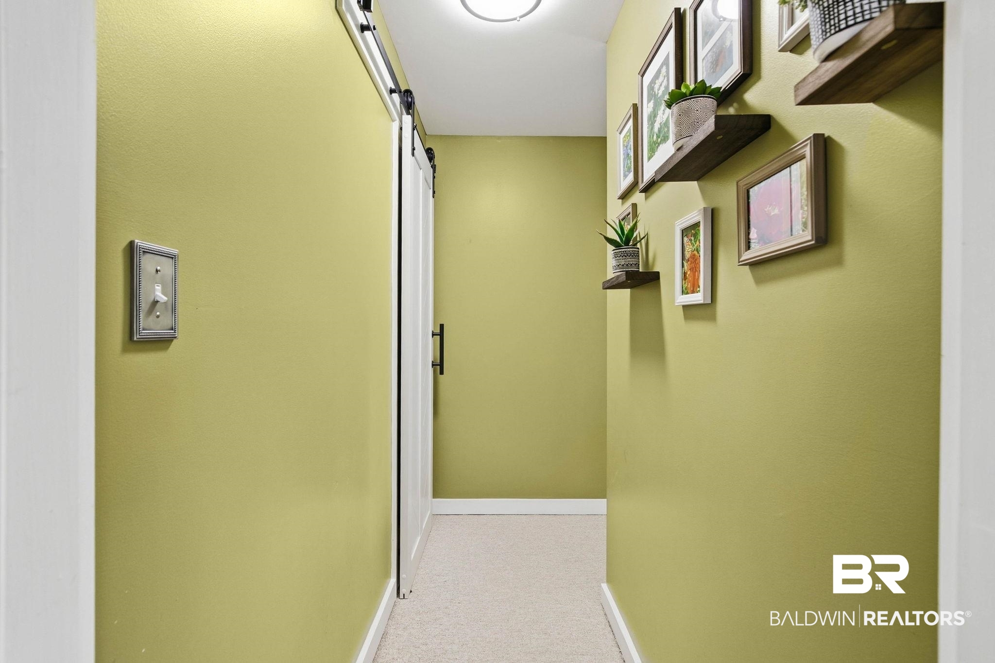 31515 Rhett Drive Spanish Fort, AL 36527 - Photo 60 of 100 Bedroom 5 has a separate locked entry hallway that exits through the garage. There is also a barn door to the storage room off the hall.
