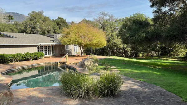 a view of a bedroom with furniture and window