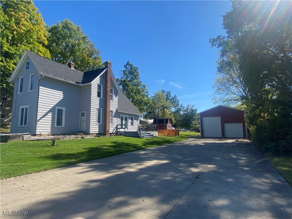 3016 Wadsworth Road Norton, OH 44203 - Photo 1 of 50 View of home's exterior featuring a yard, an outdoor structure, and a garage