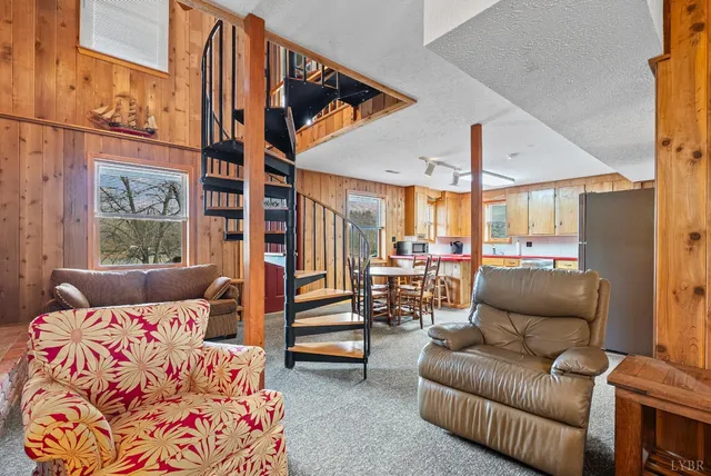 a living room with furniture a large window and potted plants