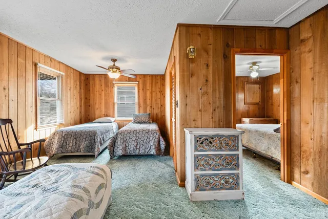 a bed sitting in a bedroom next to a window