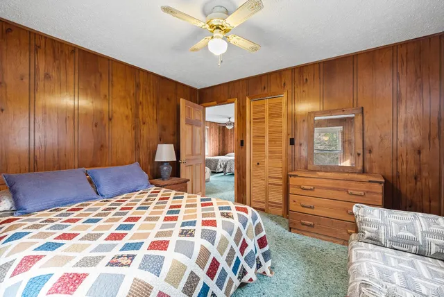 a bedroom with a bed dresser and a window