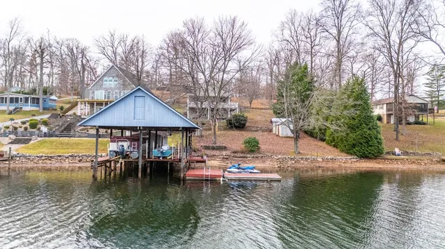 a view of a lake with couches chairs and a table