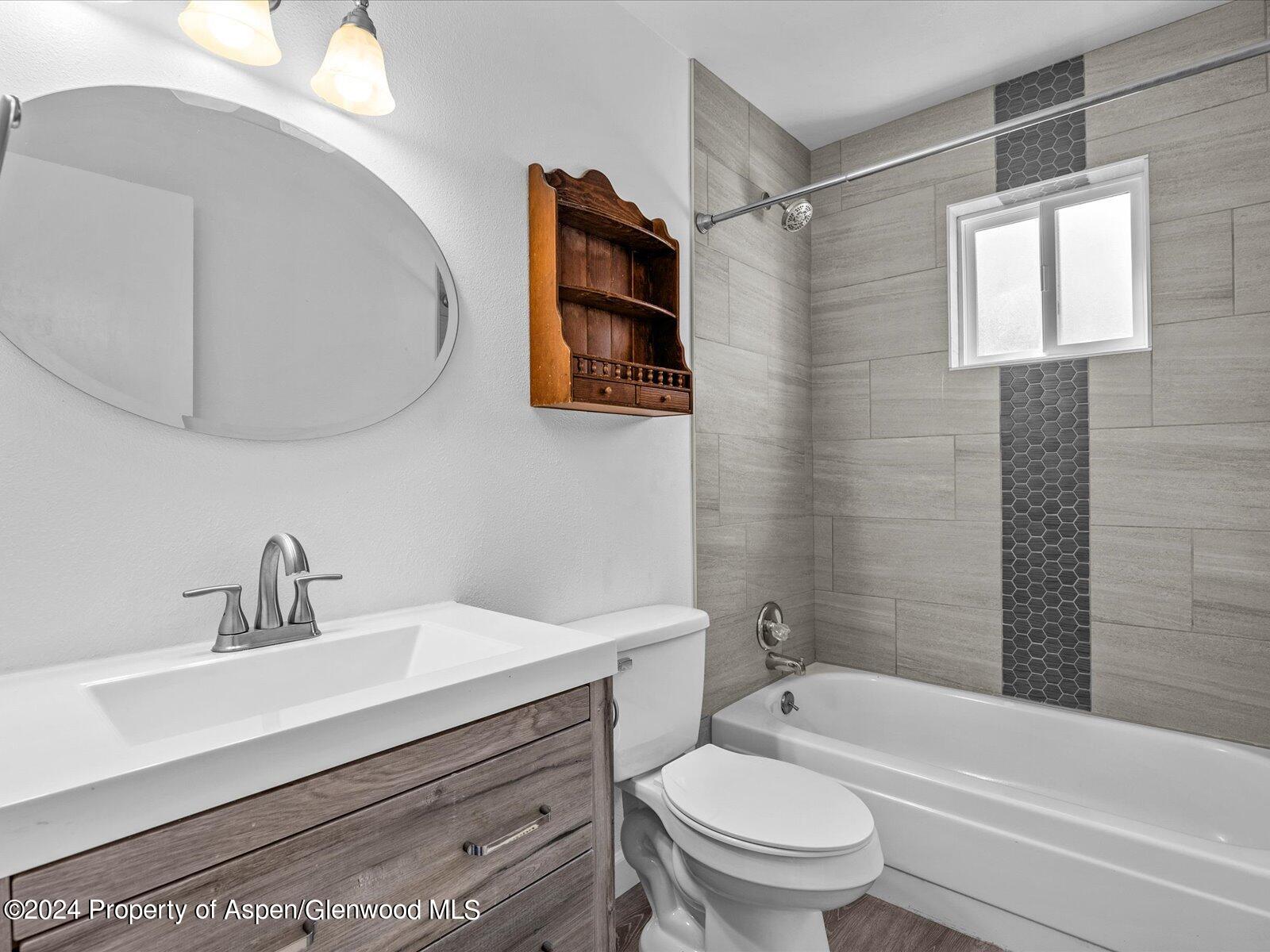 1178 East 8th Street Rifle, CO 81650 - Photo 13 of 28 a bathroom with a sink a toilet and shower