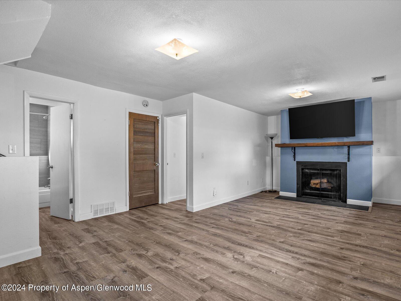 1178 East 8th Street Rifle, CO 81650 - Photo 18 of 28 a view of an empty room with a fireplace