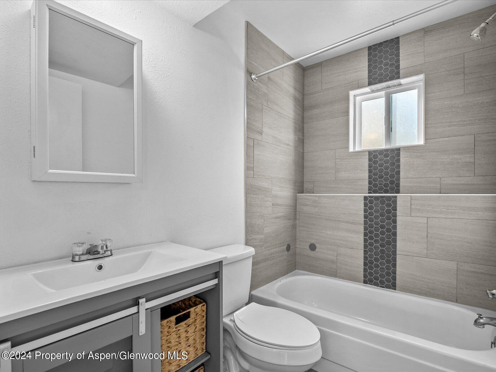 1178 East 8th Street Rifle, CO 81650 - Photo 21 of 28 a bathroom with a sink toilet and shower