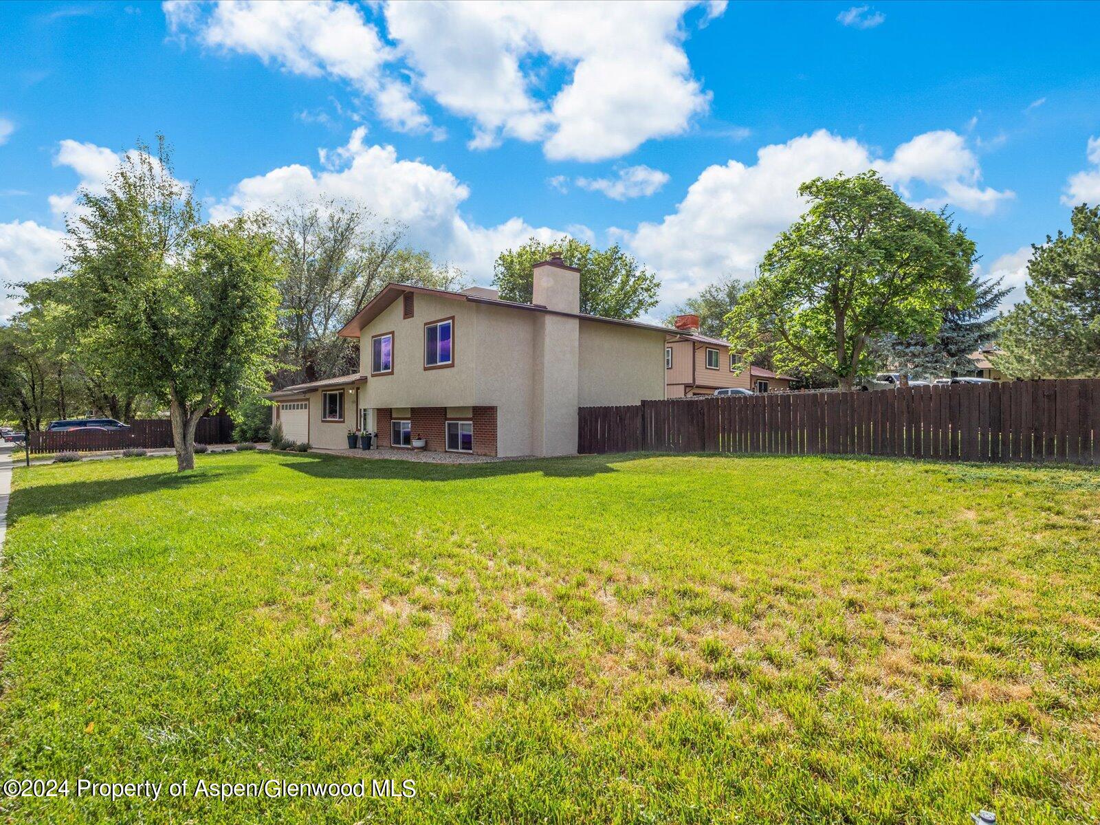 1178 East 8th Street Rifle, CO 81650 - Photo 22 of 28 a view of a house with backyard and tree