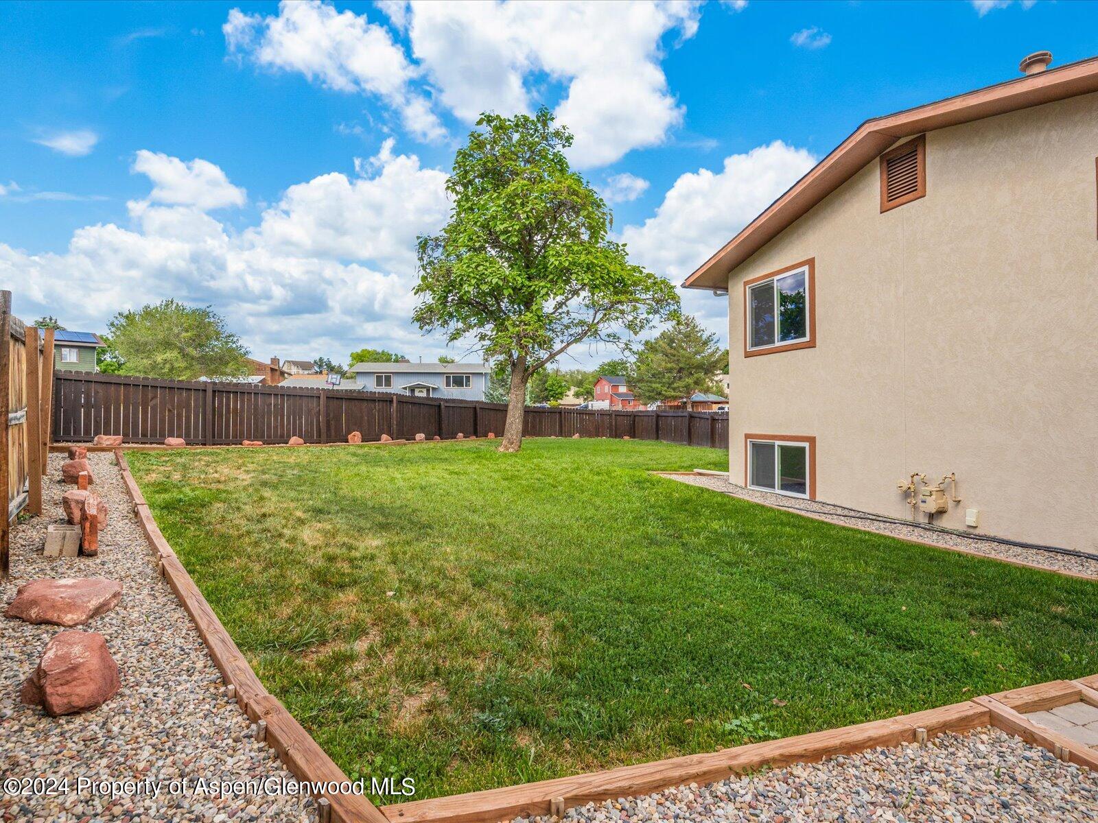 1178 East 8th Street Rifle, CO 81650 - Photo 24 of 28 a view of backyard with a garden and deck