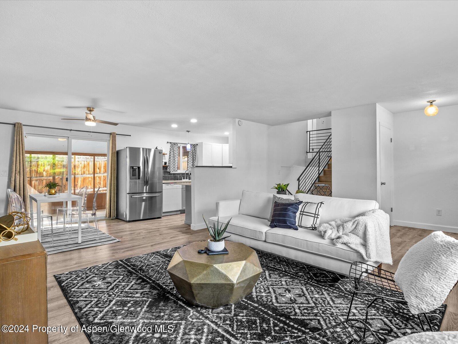 1178 East 8th Street Rifle, CO 81650 - Photo 5 of 28 a living room with furniture and a table