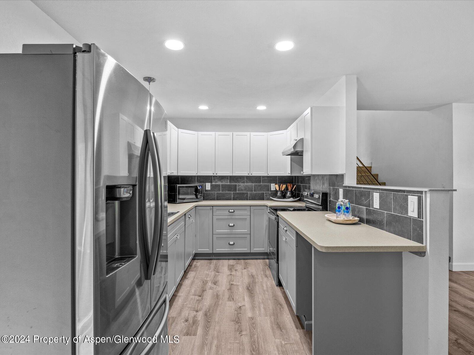 1178 East 8th Street Rifle, CO 81650 - Photo 9 of 28 a kitchen with a sink stainless steel appliances and white cabinets