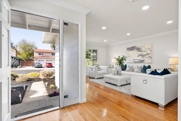a living room with furniture and wooden floor