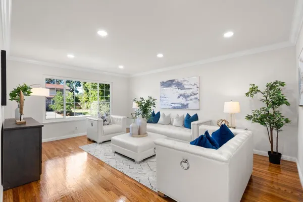 a living room with furniture ceiling fan and a window