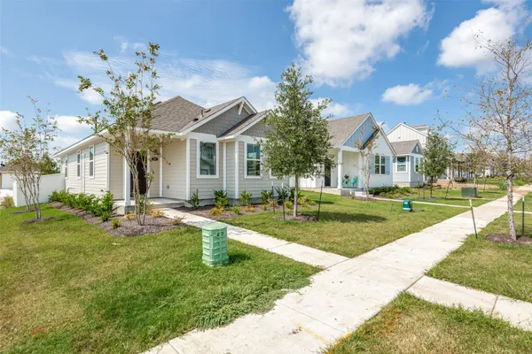 a front view of a house with swimming pool and garden