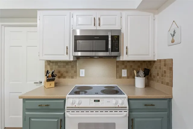 a kitchen with a stove and a microwave
