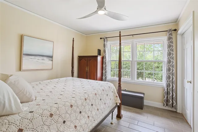 a bedroom with a large bed and a window