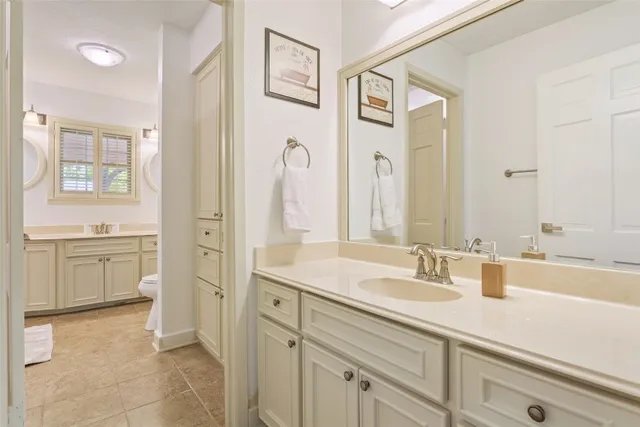 a en suite bathroom with a sink double vanity and a mirror