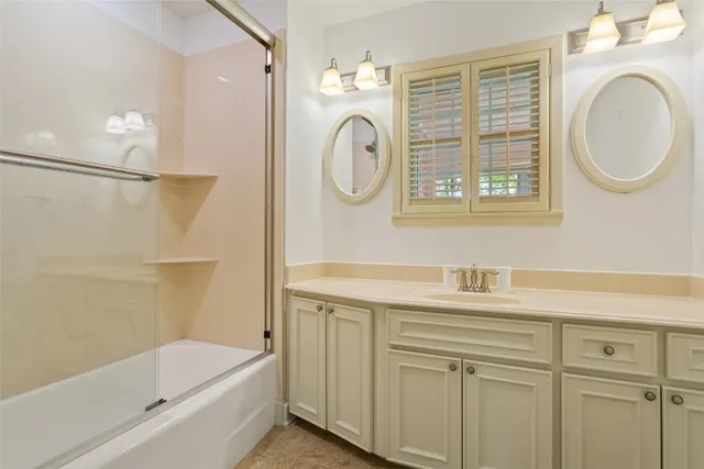 a bathroom with a granite countertop sink a toilet and a bathtub