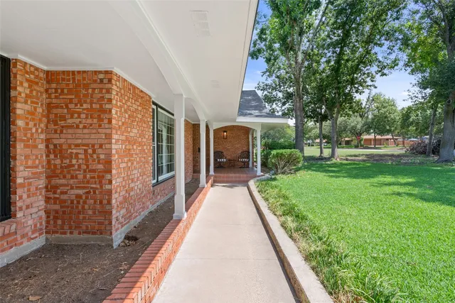 a view of house with backyard outdoor seating and green space