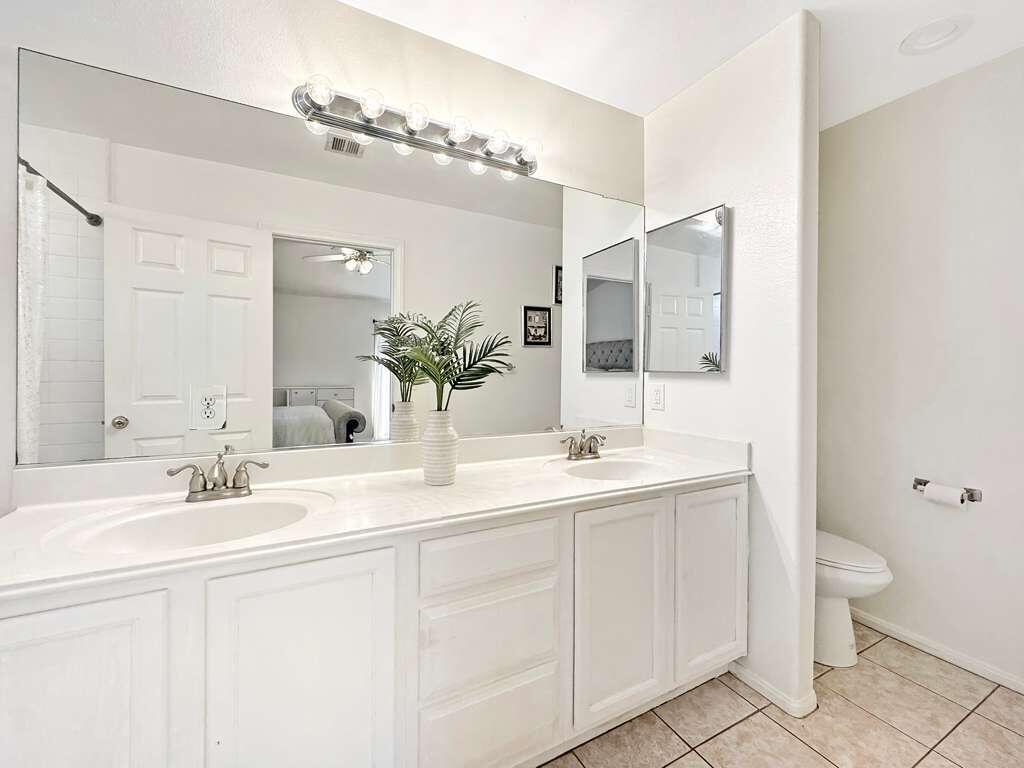 67755 Ontina Road Cathedral City, CA 92234 - Photo 19 of 30 a bathroom with a double vanity sink mirror and toilet