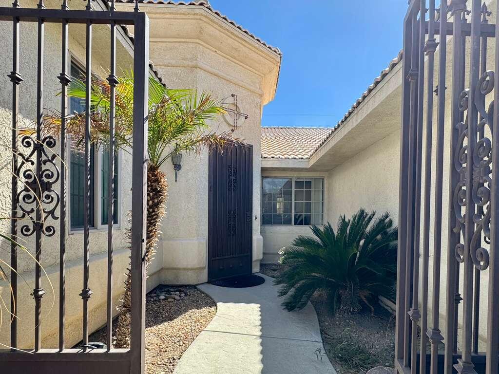 67755 Ontina Road Cathedral City, CA 92234 - Photo 2 of 30 a yellow house with trees in front