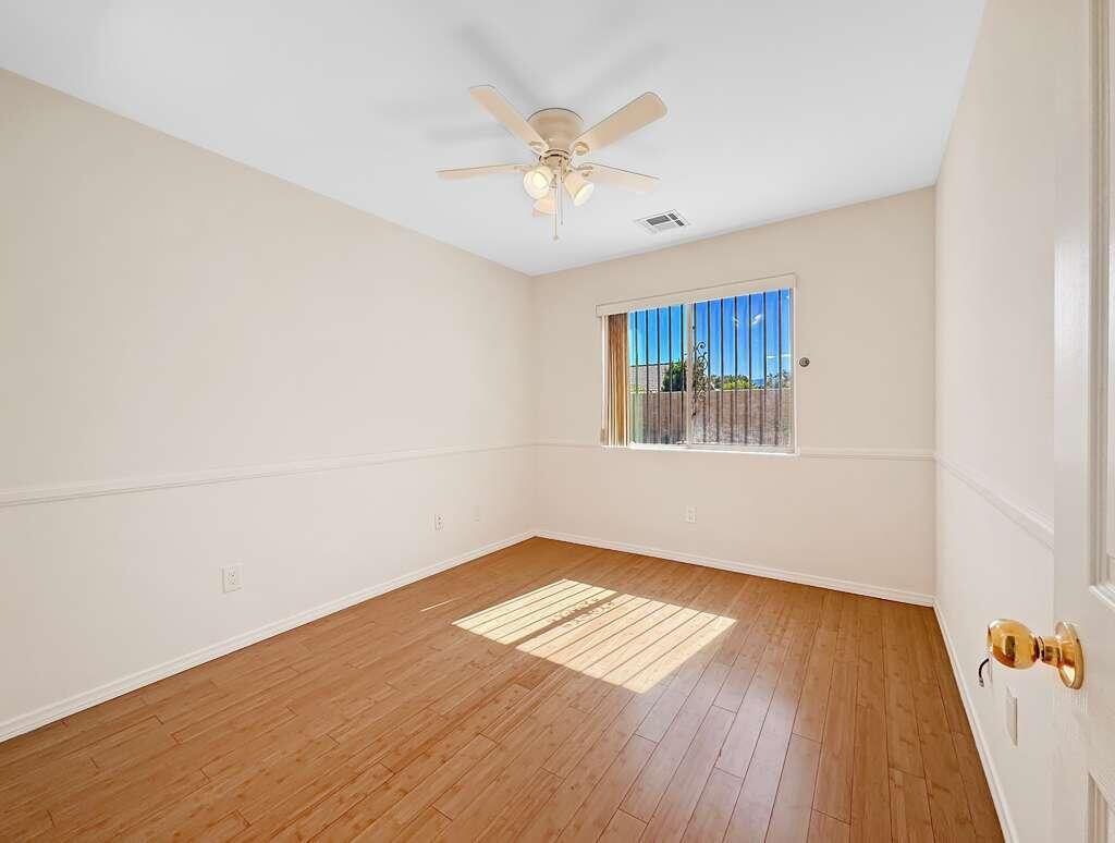 67755 Ontina Road Cathedral City, CA 92234 - Photo 21 of 30 wooden floor in an empty room with a window