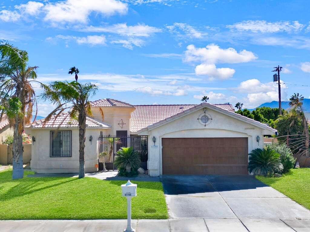 67755 Ontina Road Cathedral City, CA 92234 - Photo 29 of 30 a front view of a house with a garden and yard