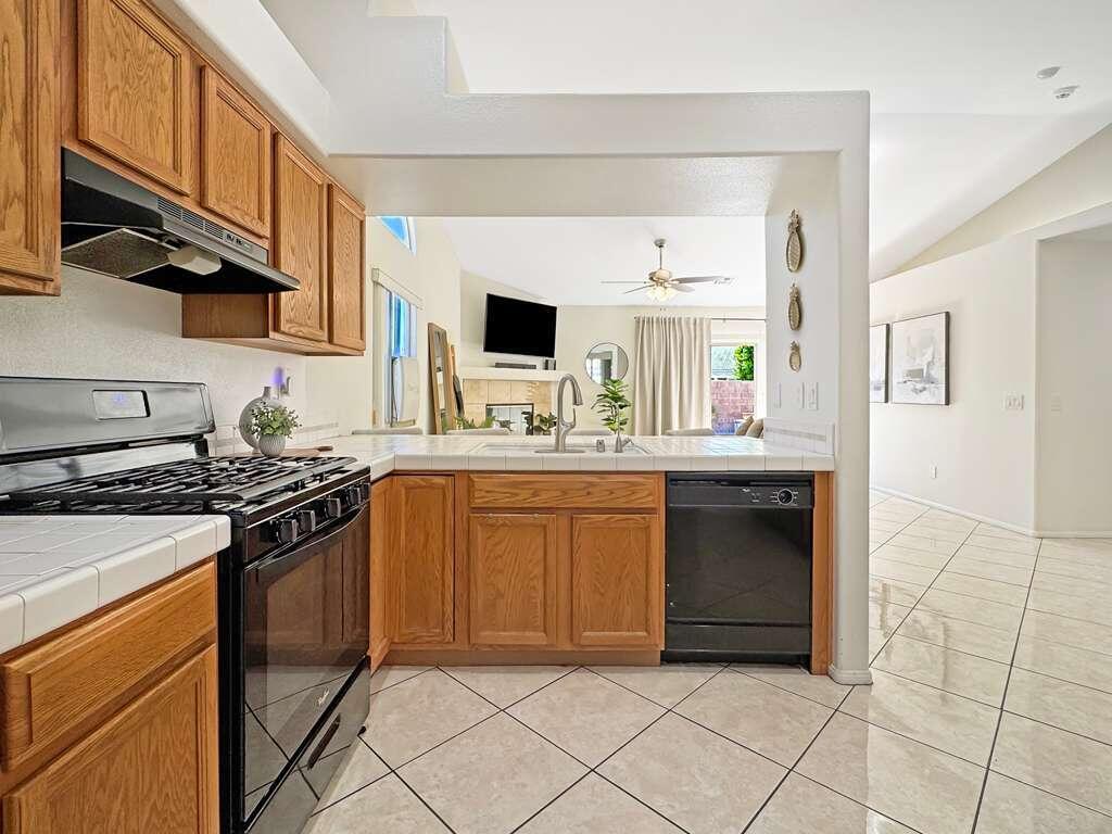 67755 Ontina Road Cathedral City, CA 92234 - Photo 9 of 30 a kitchen with stainless steel appliances granite countertop a stove a sink and a refrigerator