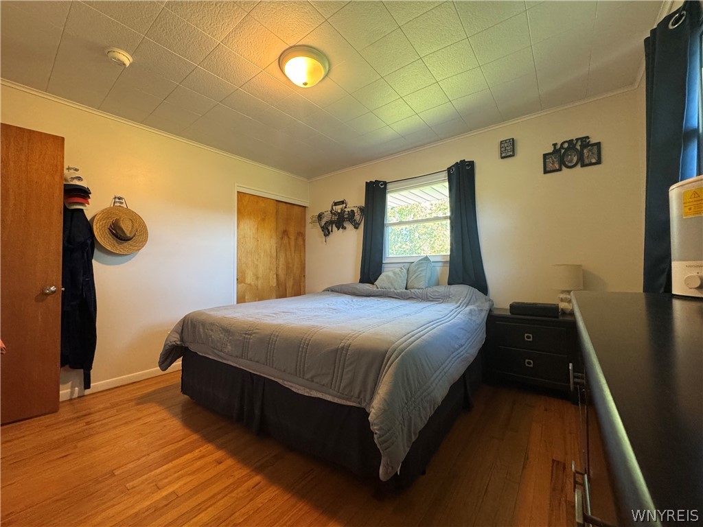 10180 Partridge Road Colden, NY 14080 - Photo 15 of 34 Rich hardwood floors anchor this bedroom, complete with textured ceiling tiles and natural window light.