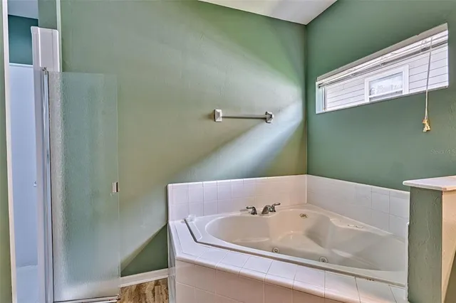 a bathroom with a bathtub and shower