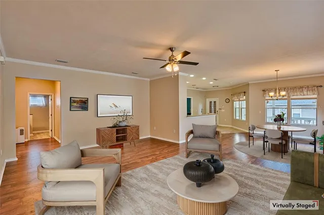 a living room with furniture a wooden floor and a chandelier