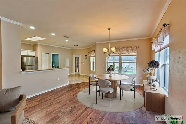 a view of a dining room with furniture window and wooden floor