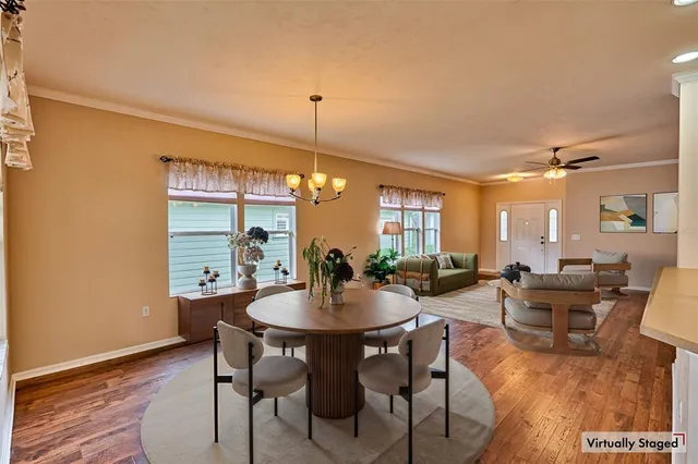 a view of a dining room with furniture window and wooden floor
