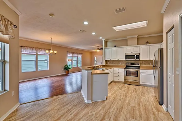 a kitchen with a refrigerator and a stove top oven