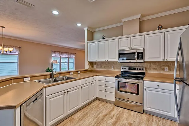 a kitchen with appliances a sink and cabinets