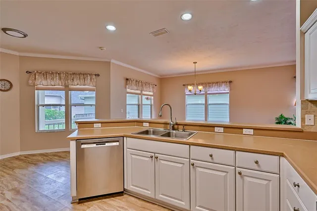 a kitchen that has a sink and a stove in it
