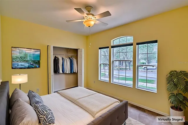 a bedroom with a bed and a large window
