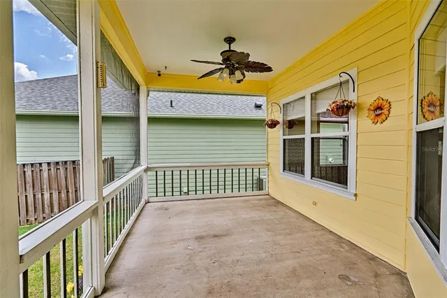 a view of a porch with wooden floor and fence