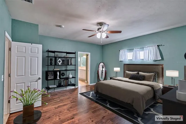 a bedroom with a large bed and a book shelf