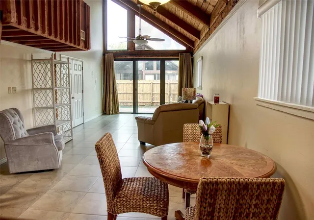 a dining room with furniture and wooden floor