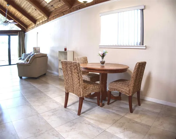 a dining room with furniture and a window