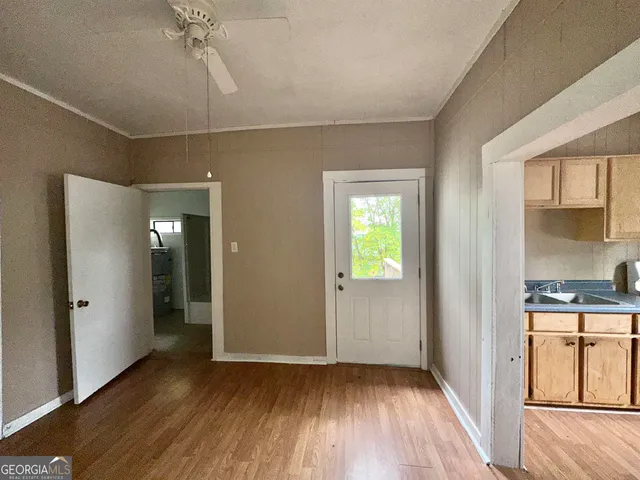 wooden floor in an empty room with a window