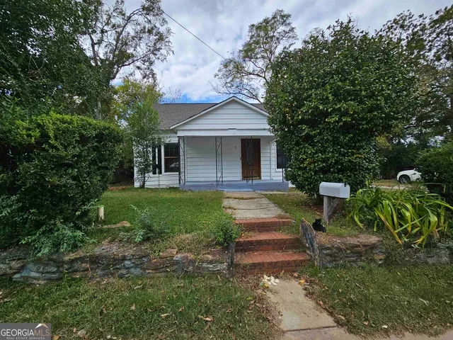a view of backyard of house with green space