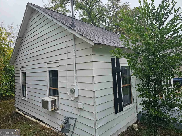 a front view of a house with plants