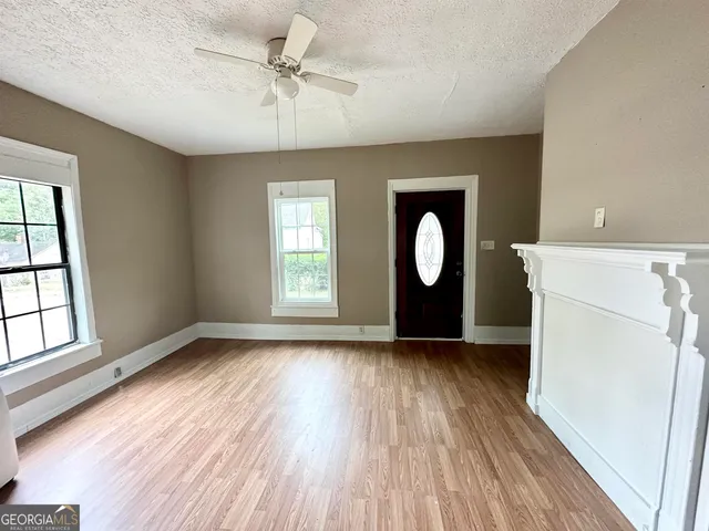 wooden floor in an empty room with a window