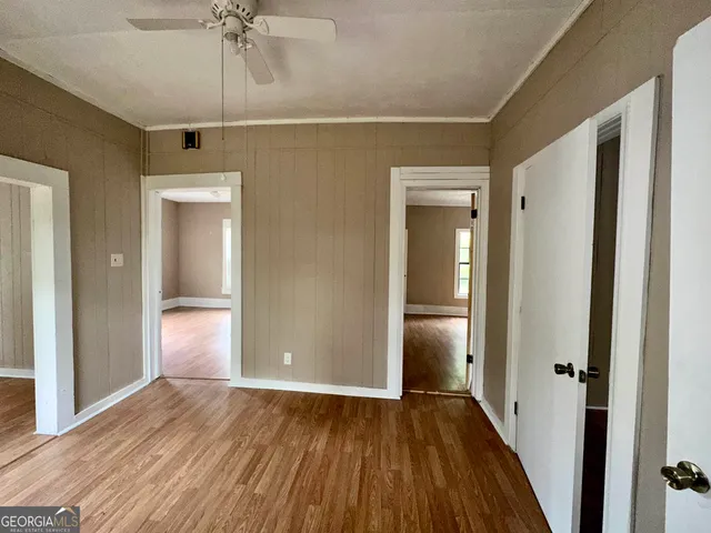 a view of empty room with wooden floor