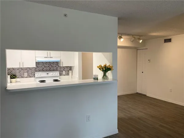 a kitchen with a sink and cabinets
