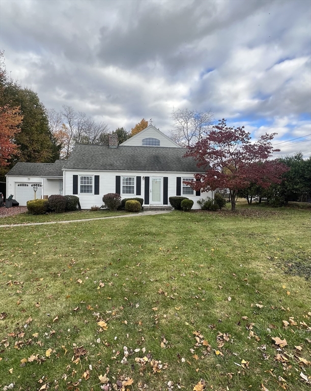 a view of a house with a big yard and large trees