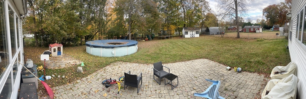 43 Birchland Avenue Springfield, MA 01119 - Photo 17 of 18 a view of a backyard with a patio and fire pit